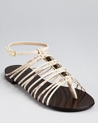 Strappy and sleek, these snakeskin embossed sandals from Guiseppe Zanotti showcase a caged silhouette with shining golden details. Strappy and sleek, these snakeskin embossed sandals from Guiseppe Zanotti showcase a caged silhouette with shining golden details.