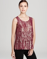 Metallic florals glow against a tiered DKNY blouse for a modern feminine statement. Style with sleek skinnies and ignite the night. Metallic florals glow against a tiered DKNY blouse for a modern feminine statement. Style with sleek skinnies and ignite the night.