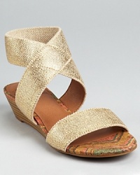 A stacked demi wedge gives a light lift to these Lucky Brand sandals, shimmering in metallic linen. A stacked demi wedge gives a light lift to these Lucky Brand sandals, shimmering in metallic linen.