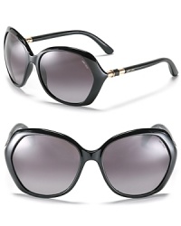 Angular oversized frames with goldtone bars and leather detail along temples for chic style. Angular oversized frames with goldtone bars and leather detail along temples for chic style.