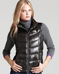 A perfect layering piece, this vest is a must have for outdoor activities on brisk winter days. A short length and glossy finish add a flirty feel to this sporty-chic layer. A perfect layering piece, this vest is a must have for outdoor activities on brisk winter days. A short length and glossy finish add a flirty feel to this sporty-chic layer.