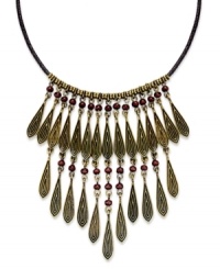 Dress your neckline with classic elegance with this bib necklace from Lauren Ralph Lauren. Teardrop beads in golden tones are paired with round accents. Strung from a brown fabric cord. Crafted from gold tone mixed metal. Approximate length: 16 inches + 2-inch extender. Approximate drop: 3-1/2 inches. Dress your neckline with classic elegance with this bib necklace from Lauren Ralph Lauren. Teardrop beads in golden tones are paired with round accents. Strung from a brown fabric cord. Crafted from gold tone mixed metal. Approximate length: 16 inches + 2-inch extender. Approximate drop: 3-1/2 inches.