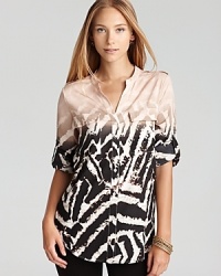 Emboldened by a graphic zebra print, this Calvin Klein top lends exotic inspiration to your everyday look. Finish with tribal accents and take charge of the fashion pack. Emboldened by a graphic zebra print, this Calvin Klein top lends exotic inspiration to your everyday look. Finish with tribal accents and take charge of the fashion pack.