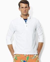 Cut in a relaxed, comfortable fit, an essential long-sleeved polo shirt in breathable cotton mesh gets a modern update with a button-down collar for a handsome look. Cut in a relaxed, comfortable fit, an essential long-sleeved polo shirt in breathable cotton mesh gets a modern update with a button-down collar for a handsome look.