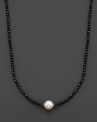 Black onyx beaded necklace with a single freshwater pearl. Black onyx beaded necklace with a single freshwater pearl.
