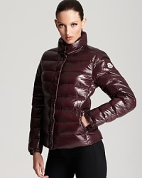 In rich burgundy and a lacquered finish, this classic Moncler puffer keeps out the cold in French aprés ski style. In rich burgundy and a lacquered finish, this classic Moncler puffer keeps out the cold in French aprés ski style.