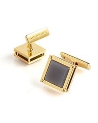 Distinguish yourself with a refined finish to your French cuff, featuring a smoky white stone surrounded by polished brass. Distinguish yourself with a refined finish to your French cuff, featuring a smoky white stone surrounded by polished brass.