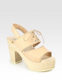 Wide leather straps with a lace-up front, secure slingback and natural wooden heel. Wooden heel, 4 (100mm)Wooden platform, 1½ (40mm)Compares to a 2½ heel (65mm)Leather upperLeather liningFoam soleMade in USAOUR FIT MODEL RECOMMENDS ordering true whole size; ½ sizes should order the next whole size down. Wide leather straps with a lace-up front, secure slingback and natural wooden heel. Wooden heel, 4 (100mm)Wooden platform, 1½ (40mm)Compares to a 2½ heel (65mm)Leather upperLeather liningFoam soleMade in USAOUR FIT MODEL RECOMMENDS ordering true whole size; ½ sizes should order the next whole size down.