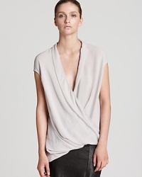 Master the elegance of draping in this Helmut Lang top with a low, crossover neckline and asymmetric hem. Slip into softness and refresh your look with luxury. Master the elegance of draping in this Helmut Lang top with a low, crossover neckline and asymmetric hem. Slip into softness and refresh your look with luxury.