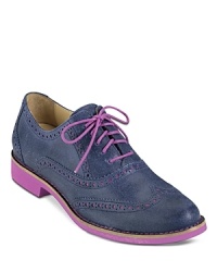 These not-so-basic Cole Haan flats are a funky take on the classic perforated oxford, with snappy pink accents that update the look. These not-so-basic Cole Haan flats are a funky take on the classic perforated oxford, with snappy pink accents that update the look.