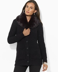 A chunky-knit cardigan is a cozy essential and has been given a luxe update with a detachable faux-fur collar for added elegance. A chunky-knit cardigan is a cozy essential and has been given a luxe update with a detachable faux-fur collar for added elegance.