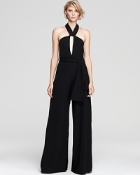 A beloved retro-silhouette makes a glamorous comeback for fall--this glamorous Alexis jumpsuit offers a flattering halter-back neckline with an elegant wide-leg drape for a dramatic look disguised in an effortless one-piece silhouette. A beloved retro-silhouette makes a glamorous comeback for fall--this glamorous Alexis jumpsuit offers a flattering halter-back neckline with an elegant wide-leg drape for a dramatic look disguised in an effortless one-piece silhouette.