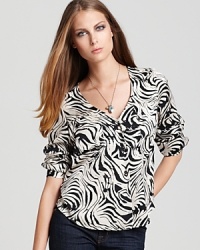 Revitalize your wardrobe with this silky-light Dolce Vita top enlivened with an on-trend zebra print. Revitalize your wardrobe with this silky-light Dolce Vita top enlivened with an on-trend zebra print.