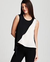 The utilitarian city wardrobe gets artistic reimagining with this DKNY tank, touting asymmetric color blocking in bold black and white for real modern edge. The utilitarian city wardrobe gets artistic reimagining with this DKNY tank, touting asymmetric color blocking in bold black and white for real modern edge.