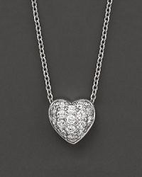A diamond pavé heart necklace. With signature ruby accent. Designed by Roberto Coin. A diamond pavé heart necklace. With signature ruby accent. Designed by Roberto Coin.