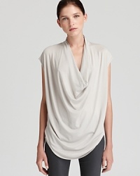 A chic draped neckline brings effortless elegance to this voluminous Helmut Lang top. A chic draped neckline brings effortless elegance to this voluminous Helmut Lang top.