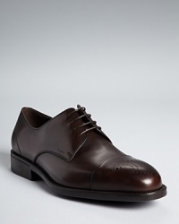 Brogue detail, usually reserved for wingtips, adorns the cap toe of these handsome dress shoes for a unique addition to your distinguished wardrobe. Brogue detail, usually reserved for wingtips, adorns the cap toe of these handsome dress shoes for a unique addition to your distinguished wardrobe.