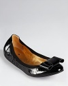A modern bow lends a charming touch to a classic flat in patent leather. From kate spade new york.