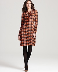 With a nod to the ‘70s, a bold retro plaid and flawless tie neckline lend timeless sophistication to this RAOUL dress. With a nod to the ‘70s, a bold retro plaid and flawless tie neckline lend timeless sophistication to this RAOUL dress.