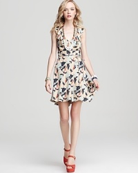 This Juicy Couture dress goes full-on feminine with decadent neckline ruffles and a playful iris print. This Juicy Couture dress goes full-on feminine with decadent neckline ruffles and a playful iris print.