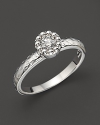 Faceted diamond set in a textured 14K. white gold band. Faceted diamond set in a textured 14K. white gold band.
