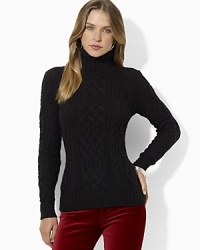 A wide cable-knit construction lends cozy appeal to a soft wool-blend sweater. A wide cable-knit construction lends cozy appeal to a soft wool-blend sweater.