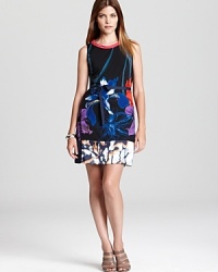 Searing blossoms glow against this sleek T Tahari dress, finished with a contrast hem for modern feminine attitude. Searing blossoms glow against this sleek T Tahari dress, finished with a contrast hem for modern feminine attitude.