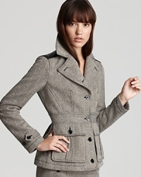 Mixing modern edge with classic sophistication, this Burberry Brit blazer flaunts a timeless tweed silhouette studded with leather shoulder and elbow patches for a pretty in punk finish.