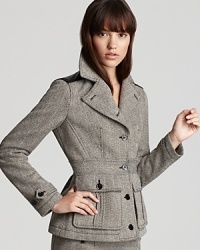 Mixing modern edge with classic sophistication, this Burberry Brit blazer flaunts a timeless tweed silhouette studded with leather shoulder and elbow patches for a pretty in punk finish. Mixing modern edge with classic sophistication, this Burberry Brit blazer flaunts a timeless tweed silhouette studded with leather shoulder and elbow patches for a pretty in punk finish.