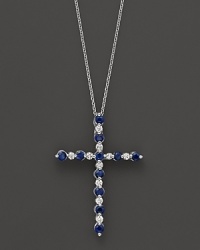Diamonds and sapphires in a 14K white gold cross pendant on a fine chain. Diamonds and sapphires in a 14K white gold cross pendant on a fine chain.
