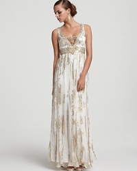 Opulent details such as an embellished mesh V-neck and flowing skirt panels place this metallic silk jacquard gown from Sue Wong in a style league of its own. Opulent details such as an embellished mesh V-neck and flowing skirt panels place this metallic silk jacquard gown from Sue Wong in a style league of its own.