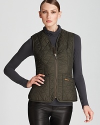 Flaunt sporty style with this quilted Barbour vest with cozy fleece lining. Flaunt sporty style with this quilted Barbour vest with cozy fleece lining.
