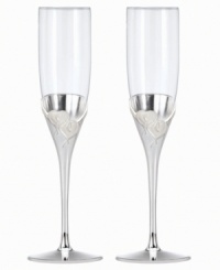 Toast your sweetie or favorite newlyweds with True Love. Interlocking hearts adorn elegant, silver-plated champagne flutes, a fitting way to commemorate every anniversary. Toast your sweetie or favorite newlyweds with True Love. Interlocking hearts adorn elegant, silver-plated champagne flutes, a fitting way to commemorate every anniversary.