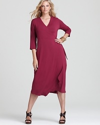 A jewel-tone palette breathes distinctive life into an Eileen Fisher Plus wrap dress, finished with an angled hem for a strikingly modern silhouette. A jewel-tone palette breathes distinctive life into an Eileen Fisher Plus wrap dress, finished with an angled hem for a strikingly modern silhouette.