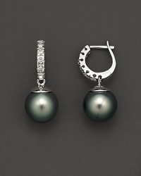 Cultured Tahitian pearls and diamond hoop earrings. Cultured Tahitian pearls and diamond hoop earrings.