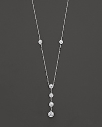 White gold bezel-set diamond necklace with four-stone drop pendant. With signature ruby accent. Designed by Roberto Coin.