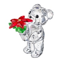 Shining in sparkling Swarovski crystal, this year's adorable Kris Bear holds a vibrant poinsettia. The year 2012 is engraved on the bear's left leg. Shining in sparkling Swarovski crystal, this year's adorable Kris Bear holds a vibrant poinsettia. The year 2012 is engraved on the bear's left leg.
