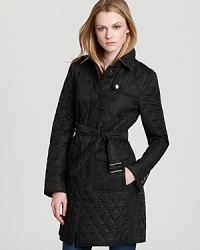 Cut a sharp silhouette in this quilted Burberry Brit coat, accented with a sleek belt for feminine appeal. Check lining lends a strong finish to the classic piece. Cut a sharp silhouette in this quilted Burberry Brit coat, accented with a sleek belt for feminine appeal. Check lining lends a strong finish to the classic piece.