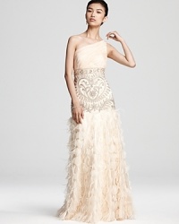 This elaborate Sue Wong gown gets glamorous with detailed beading and a dramatic, petal and feather accented skirt. This elaborate Sue Wong gown gets glamorous with detailed beading and a dramatic, petal and feather accented skirt.
