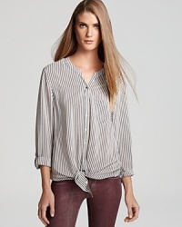 Slim, hypnotic stripes add texture and definition to this elegant Joie blouse, rendered in pure silk. Slim, hypnotic stripes add texture and definition to this elegant Joie blouse, rendered in pure silk.