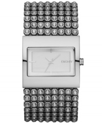 Bare your bling. This gorgeous DKNY watch features a crystal-accented stainless steel bracelet and rectangular case. Matte silvertone sunray dial with silvertone stick indices and logo. Quartz movement. Water resistant to 30 meters. Two-year limited warranty. Bare your bling. This gorgeous DKNY watch features a crystal-accented stainless steel bracelet and rectangular case. Matte silvertone sunray dial with silvertone stick indices and logo. Quartz movement. Water resistant to 30 meters. Two-year limited warranty.