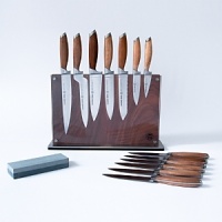 German stainless steel harmonizes with Asian teak wood on this superior set of knives from Schmidt Brothers for an aesthetically pleasing and exceptionally precise collection. The set includes an 8 Slicer Knife, 6 Petit Chef Knife, 7 Deli Knife, 6 Double Edge Utility Knife, 6 Tomato/Bagel Knife, 4 Paring Knife, 3 Paring Knife, six 5 Steak Knives, Sharpening Stone and Downtown Block. German stainless steel harmonizes with Asian teak wood on this superior set of knives from Schmidt Brothers for an aesthetically pleasing and exceptionally precise collection. The set includes an 8 Slicer Knife, 6 Petit Chef Knife, 7 Deli Knife, 6 Double Edge Utility Knife, 6 Tomato/Bagel Knife, 4 Paring Knife, 3 Paring Knife, six 5 Steak Knives, Sharpening Stone and Downtown Block.