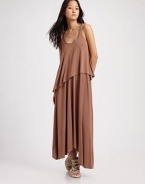 Draped jersey knit hangs in a chic, asymmetrical silhouette for modern styling.Scoopneck Wide straps Asymmetrical hem Scoopback 97% modal/3% spandex Hand wash Imported