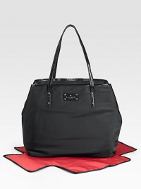 Here's a baby bag that doesn't look like one, masquerading as an elegant, leather-trimmed tote that could hold a laptop as easily as diapers.Double top handles, 9¾ drop Spring clip strap top close Stroller clips One inside open pocket One inside zip pocket Bright, wipe-clean lining Jersey-backed nylon with patent leather trim 16¼H X 12½H X 7D Imported Here's a baby bag that doesn't look like one, masquerading as an elegant, leather-trimmed tote that could hold a laptop as easily as diapers.Double top handles, 9¾ drop Spring clip strap top close Stroller clips One inside open pocket One inside zip pocket Bright, wipe-clean lining Jersey-backed nylon with patent leather trim 16¼H X 12½H X 7D Imported