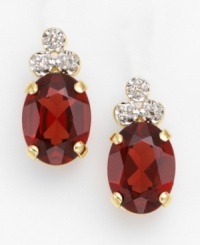 These simply elegant earrings feature three sparkling diamonds resting atop a rich garnet stone. Set in 14K gold. For pierced ears only. These simply elegant earrings feature three sparkling diamonds resting atop a rich garnet stone. Set in 14K gold. For pierced ears only.