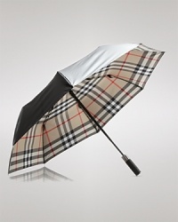 A tonal check pattern lining undergirds this protective umbrella, shading you in signature Burberry style while repelling the rain. A tonal check pattern lining undergirds this protective umbrella, shading you in signature Burberry style while repelling the rain.