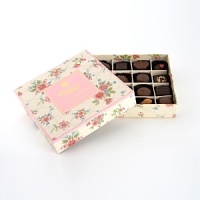 A selection of fine milk and dark chocolates in a delicately printed floral box. A selection of fine milk and dark chocolates in a delicately printed floral box.