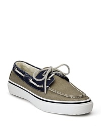 Step into the sunlight in this cool 2-tone boat shoe from Sperry, outfited in canvas with classic lace details and moc toe.