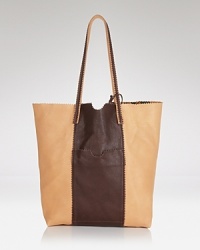 Endlessly versatile, this Carlos Falchi tote is a step beyond the tried-and-true, crafted from rich leather. It's the bag to throw over your shoulder day in and out. Endlessly versatile, this Carlos Falchi tote is a step beyond the tried-and-true, crafted from rich leather. It's the bag to throw over your shoulder day in and out.