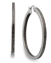 Bolder and better. Black diamonds are the latest craze in fine jewelry and these round-cut black diamond hoop earrings (1/2 ct. t.w.) will add the perfect touch to your collection. Set in sterling silver. Approximate diameter: 1-1/2 inches.